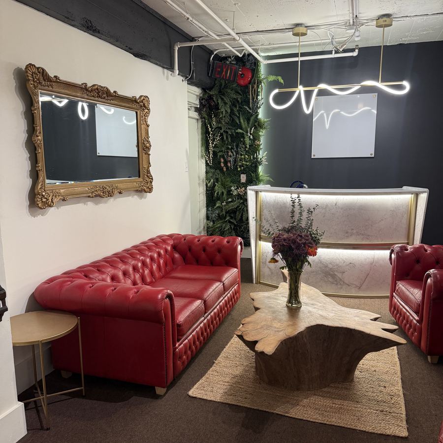 The lobby, with red leather chesterfields and the living plant wall