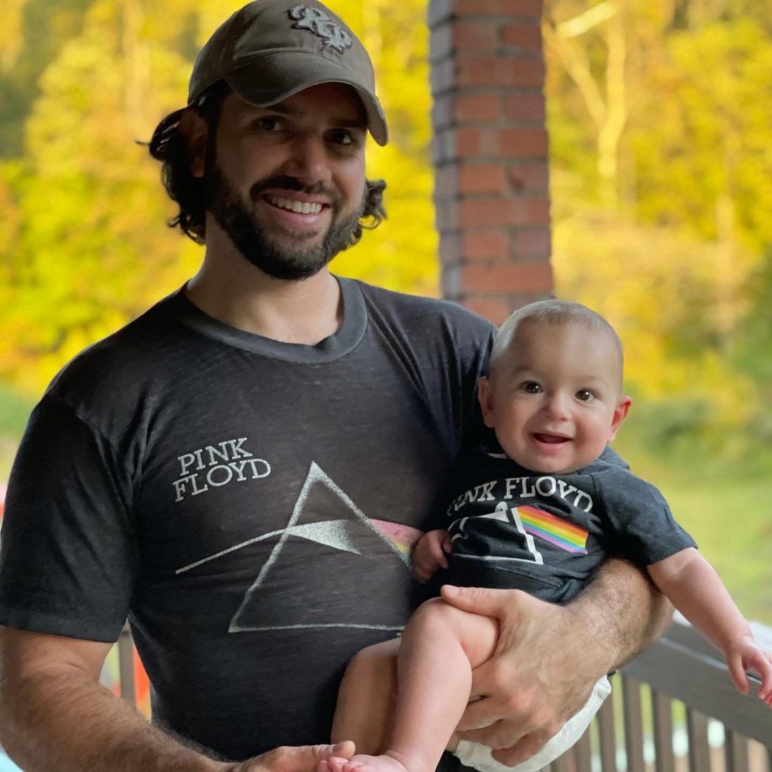 Luke Raymer, founder of Pittsburgh Float Spa, holding his son